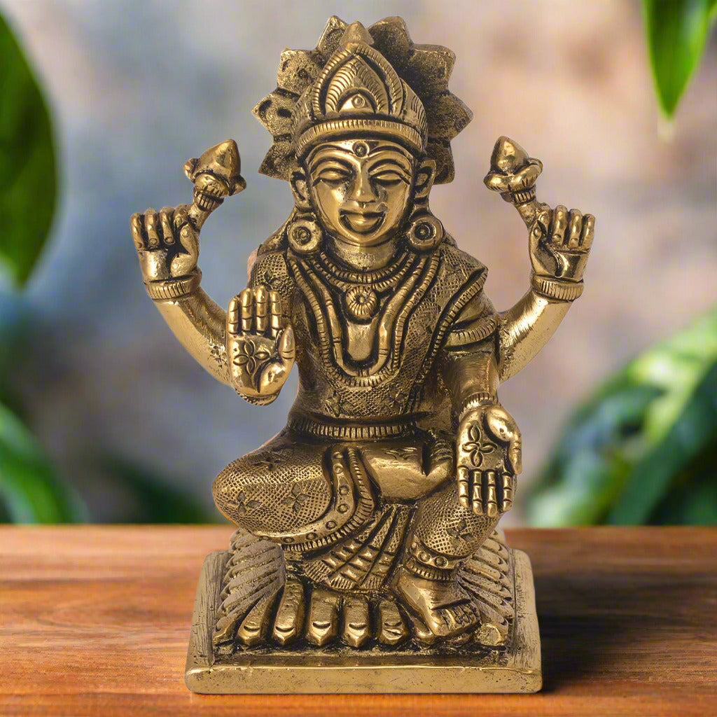 Bronze statue of a deity on a white background