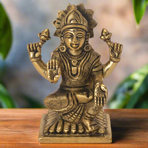 Bronze statue of a deity on a white background