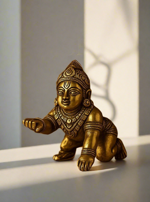 Brass Krishna statue on a brown background with text 'Every home needs a little Krishna'.